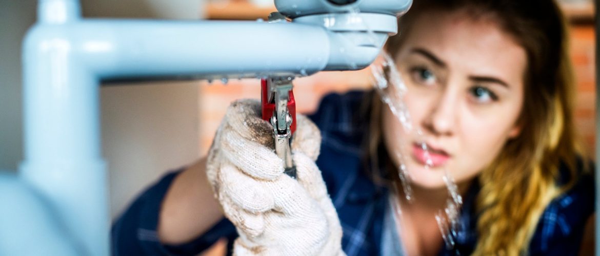 Woman fixing kitchen sink